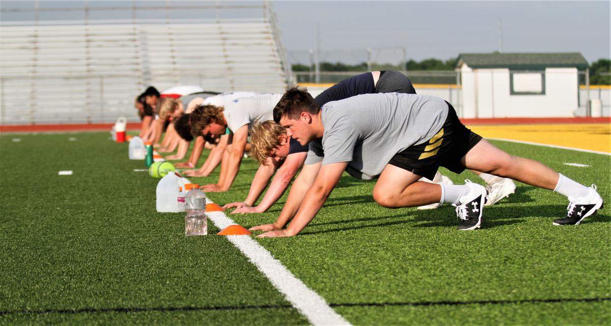 Bishop Carroll football players work out for the first time in 2020.