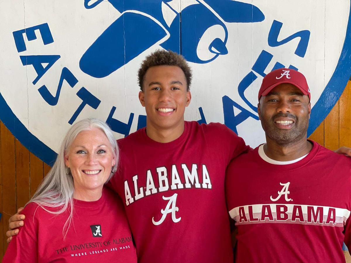 Wichita East swimmer Drayden Bell (middle) punched his ticket to the 2024 U.S. Olympic Swimming Team Trials in Indianapolis later this month.