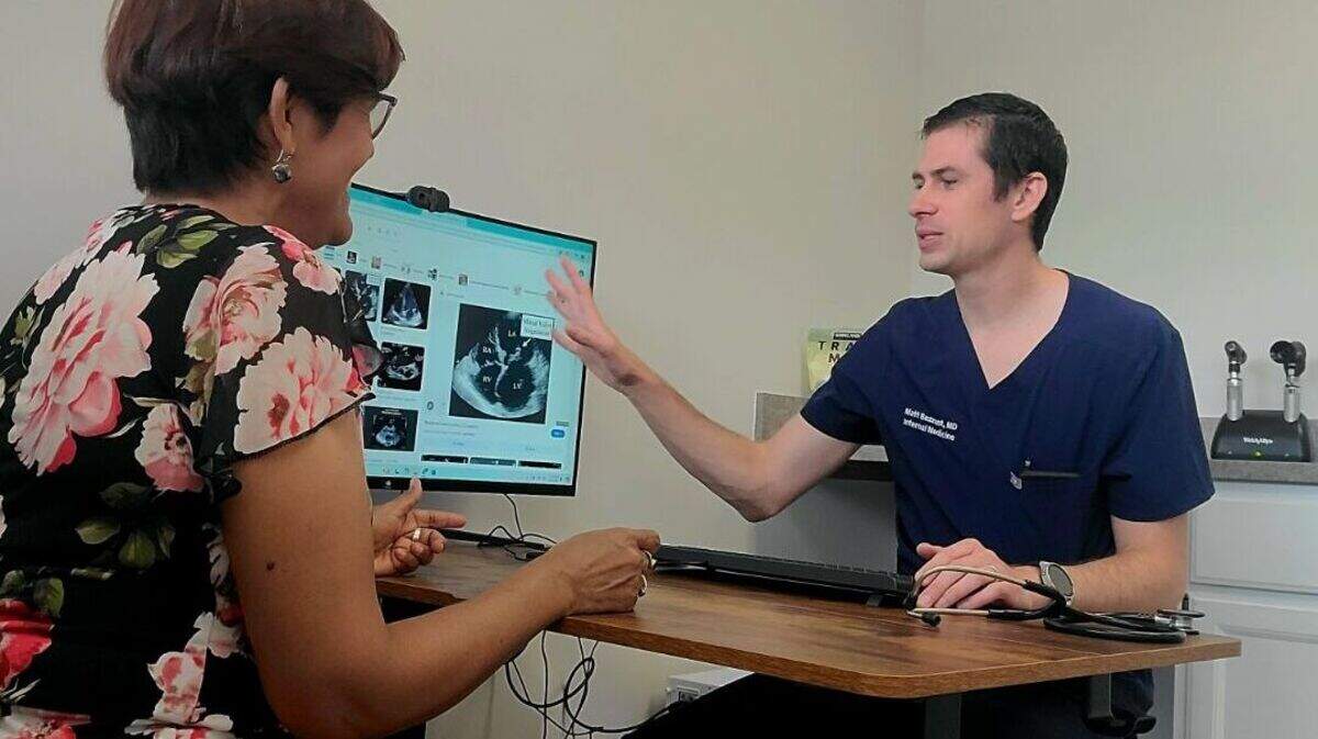Premonition Health founder Matt Bezzant, shown with a patient, said he hopes his new kind of direct-care clinic catches on with other physicians around Wichita.