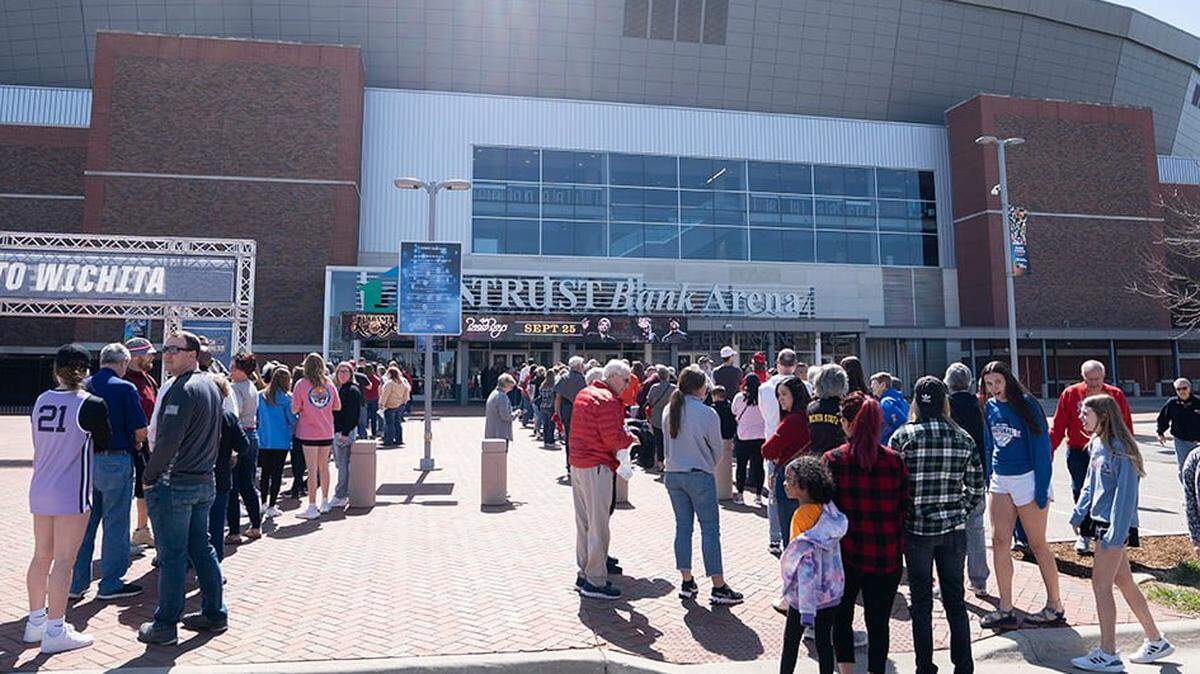 Fans wait in line to enter Intrust Bank Arena to watch Sweet 16 NCAA tournament games in Wichita on Saturday.