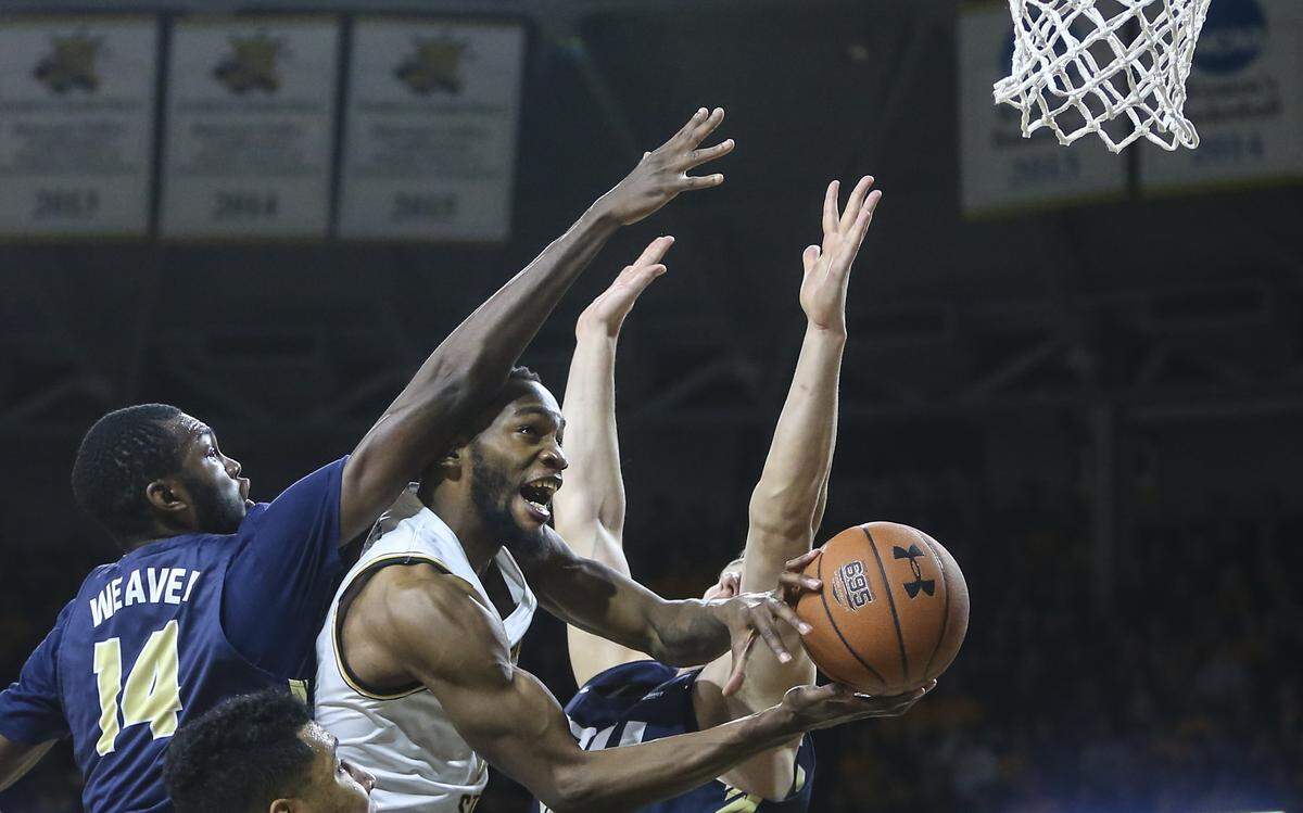 Wichita State forward Markis McDuffie goes to the basket against Oral Roberts forward D.J. Weaver during the second half of their game at Koch Arena on Wednesday.