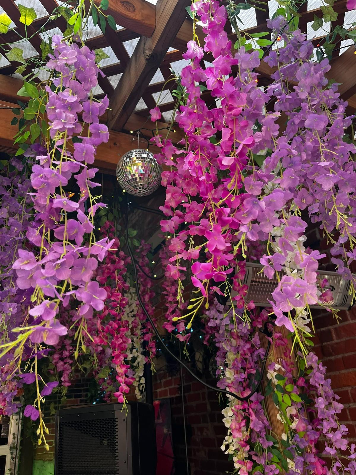 Disco balls, plant life and macrame make Public at the Brickyard’s soon-to-open pop-up bar “The Wilds” feel like a tropical night club.