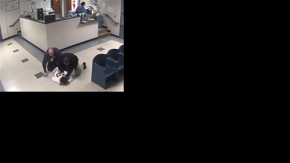 This Jan. 28, 2014 still image from jail surveillance video, provided by attorney Matthew Hoppock, shows two immigration agents in an altercation with Justine Mochama, an international student from Kenya who overstayed his visa, for refusing to be fingerprinted before deportation at the Butler County Detention Facility in El Dorado, Kan. Mochama filed a lawsuit alleging he was violently attacked by the agents and won a rare legal victory Tuesday, Jan. 3, 2017, when a federal judge ruled that his lawsuit could go to trial over the incident captured on jailhouse surveillance video. (Butler County Detention Facility surveillance video provided by attorney Matthew Hoppock via AP)
