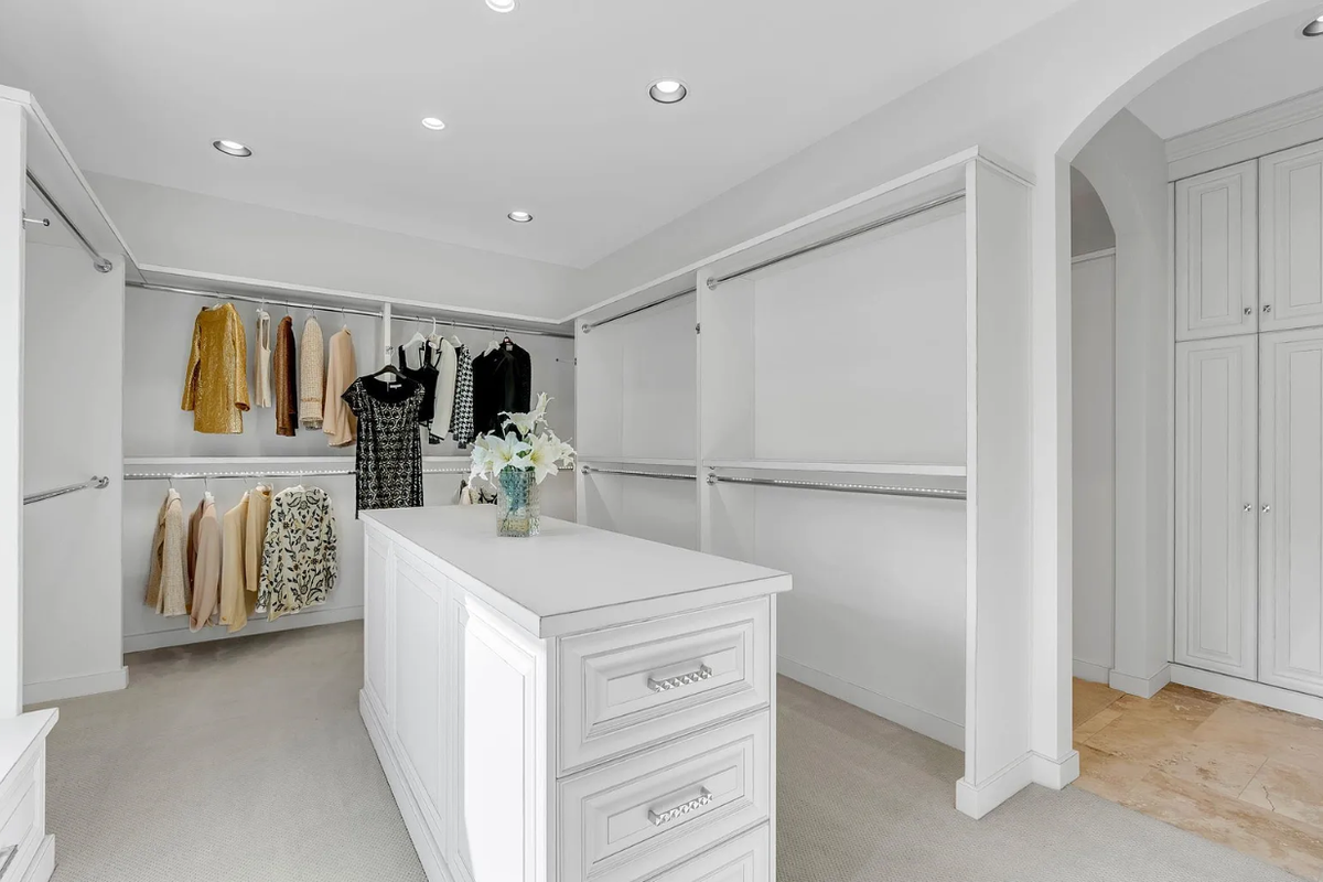 The master suite’s closet in 1440 N Gatewood St Unite 33 has chrome bars.