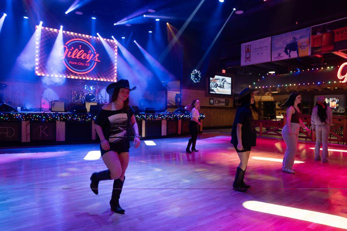 Gilley Girls, who will be responsible for creating energy and getting people to dance at the new Gilley’s honky-tonk, practice their steps ahead of Monday’s opening.