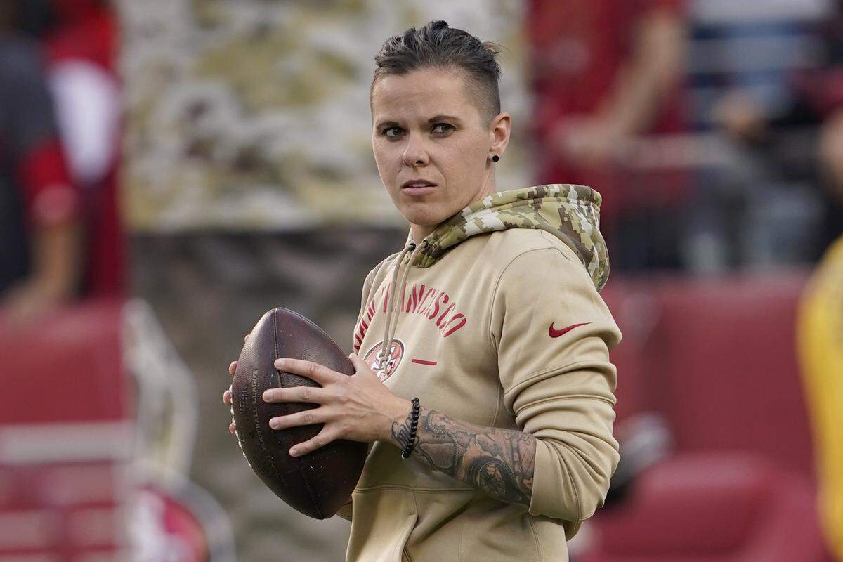 San Francisco 49ers assistant coach Katie Sowers watches as players warm up before an NFL football game between the 49ers and the Seattle Seahawks in Santa Clara, Calif., Monday, Nov. 11, 2019. (AP Photo/Tony Avelar)