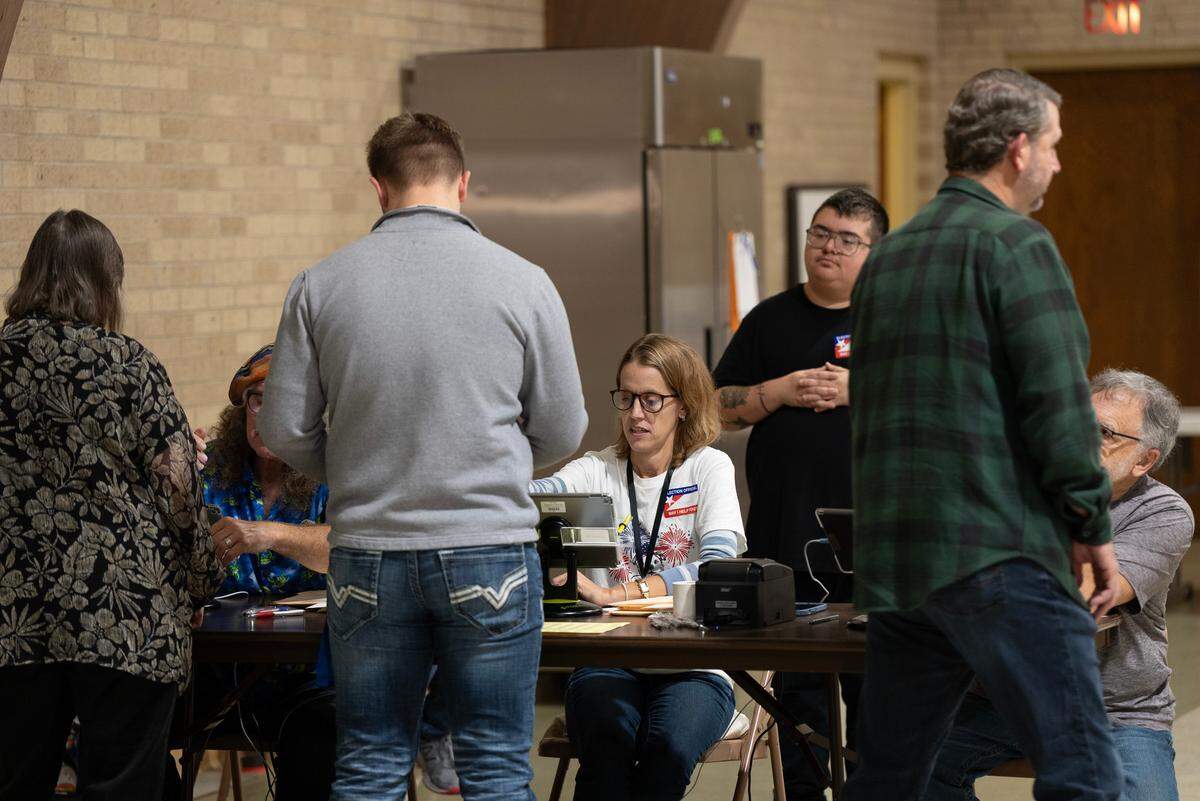 Election Day voters check in at 6:30 a.m. at Woodland United Methodist Church.