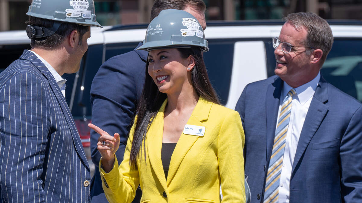 Wichita Mayor Lily Wu talks with Wichita business leader Jon Rolph during a groundbreaking ceremony for the new biomedical campus downtown. She has seen successes and setbacks in her first year in office.
