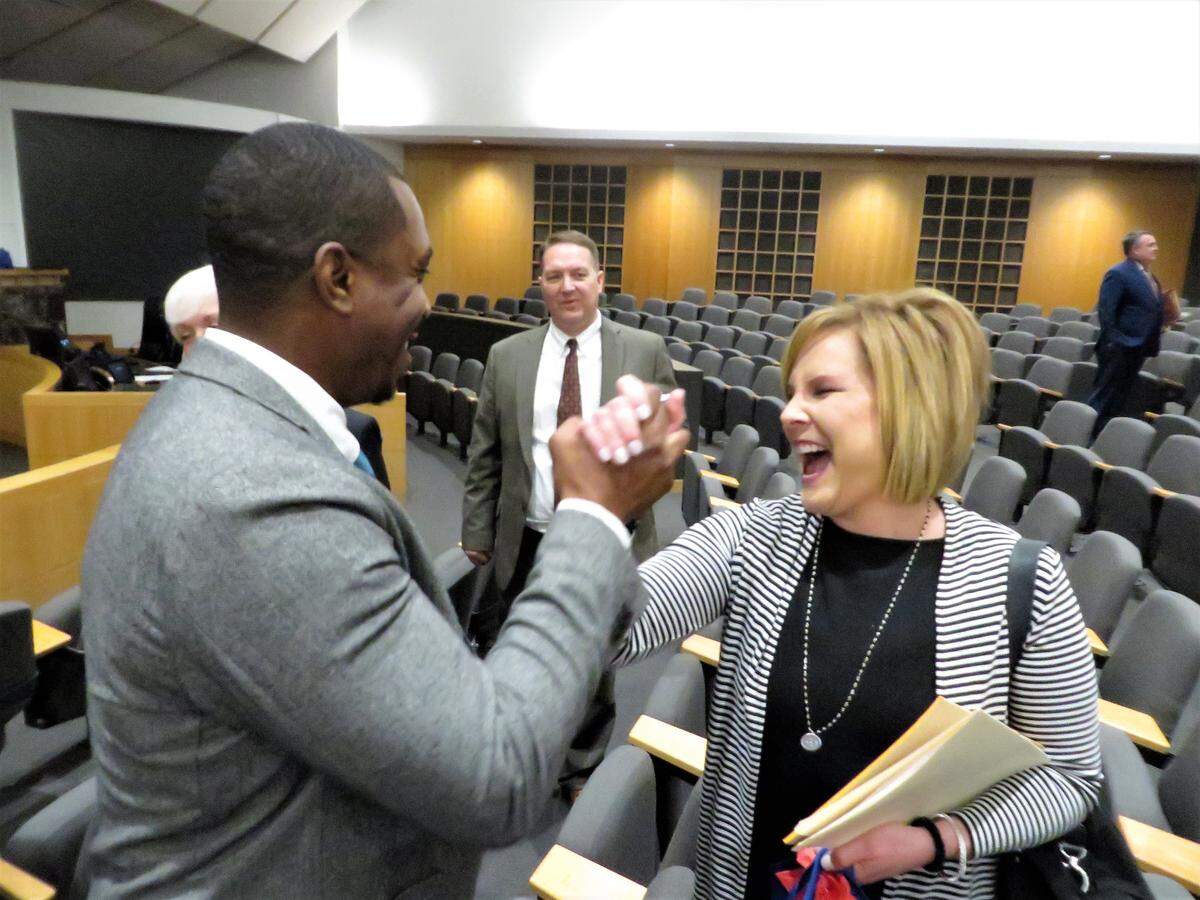 Becky Tuttle shares a high five with council member Brandon Johnson a few minutes after she was selected as the newest member of the Wichita City Council.