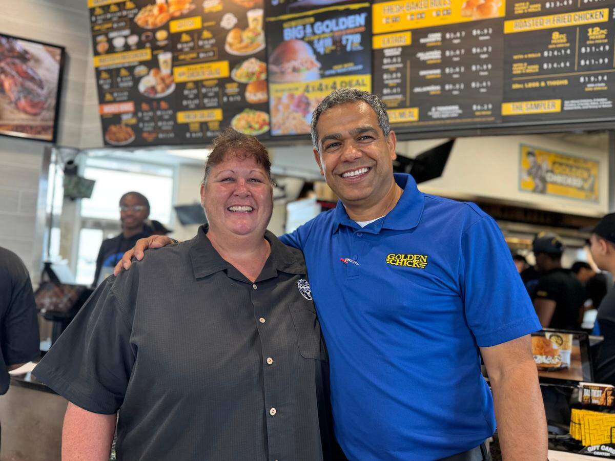 Wichita Golden Chick franchisee Adam Abusaleh is pictured in the restaurant with Golden Chick district manager Julie Burt.