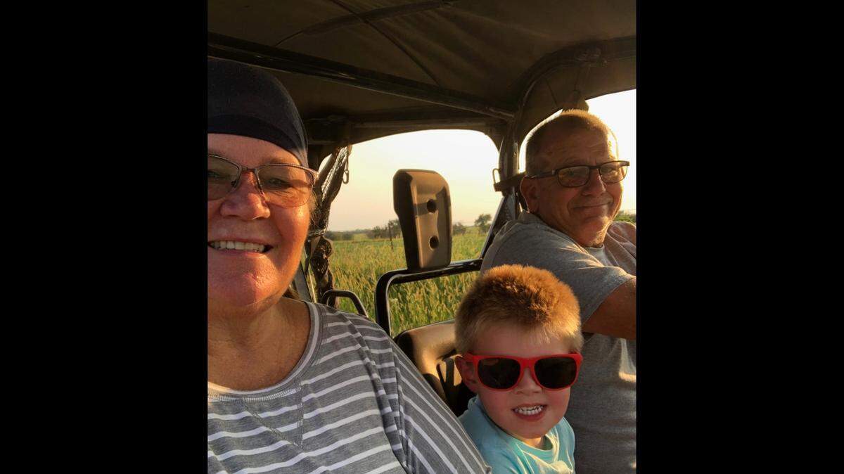 Anita and Jerry Farthing ride around in an all-terrain vehicle with one of their grandsons in summer 2020. Jerry Farthing, who was chief of the Leon Police Department, died on Friday after more than a month of battling COVID-19.