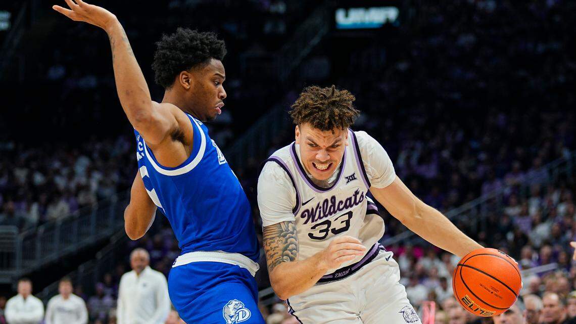 Kansas State Wildcats forward Coleman Hawkins (33) drives against Drake Bulldogs guard Tavion Banks (6) at T-Mobile Center on Dec. 17, 2024.