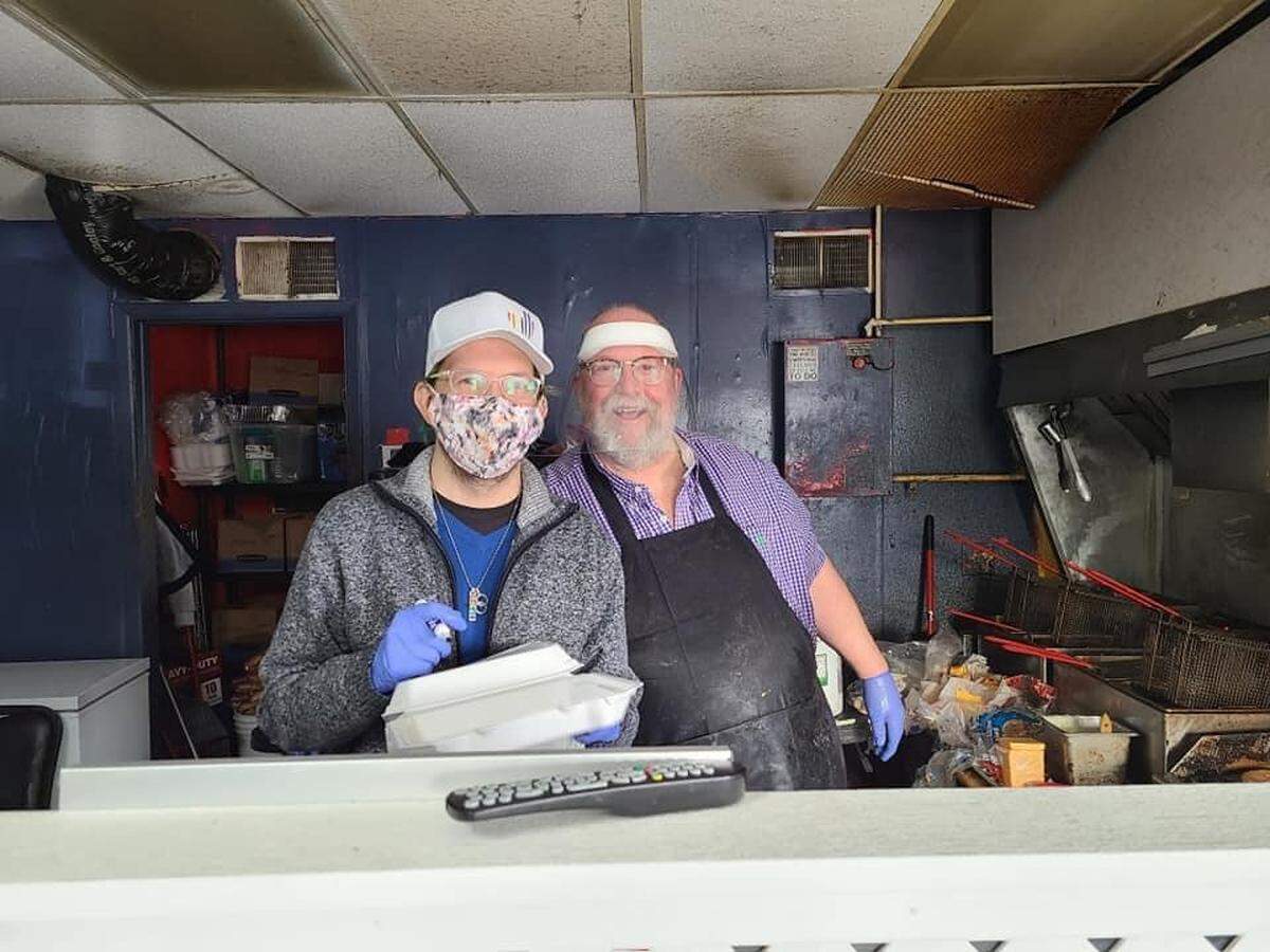 Buster Farleigh, right, has decided not to retire and will reopen his Buster’s Burger Joint on Wednesday. He’s pictured here with his son and employee Garrett Flores.