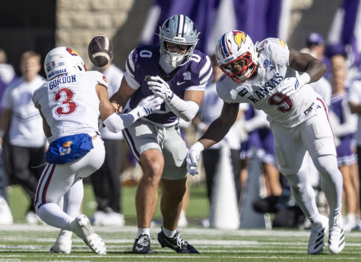 Kansas State tight end Linkon Cure fumbles the ball while Kansas safety Corey Gordon (3) and Kansas defensive end Dakyus Brinkley (9) try to recover the ball during the first half in Manhattan on Saturday, Oct. 17, 2026.