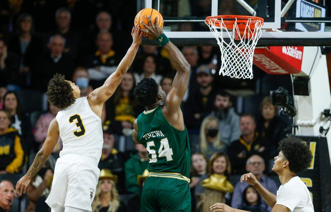 Wichita State’s Craig Porter blocks the shot of South Florida’s Russel Tchewa during the first half on Saturday at Koch Arena.