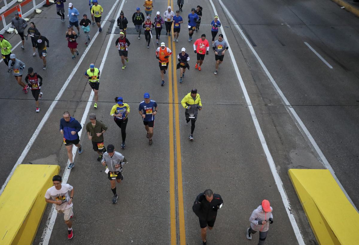 Competitors in the Prairie Fire Marathon and Half Marathon run along Douglas on Sunday.
