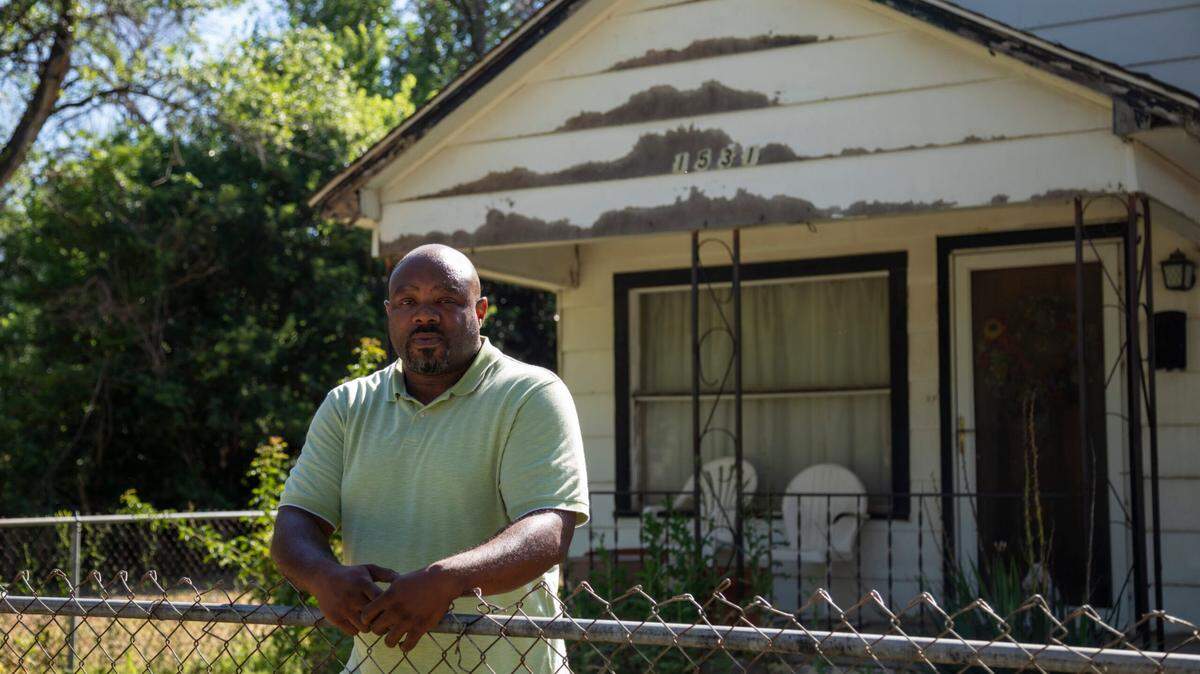 Jason Washington stands in front of his grandparents’ house at 1531 N. Green. It needs a new roof and a stabilized foundation, but he lacks the legal right to do the work. His grandfather, uncles and father built this home he is now trying to save.