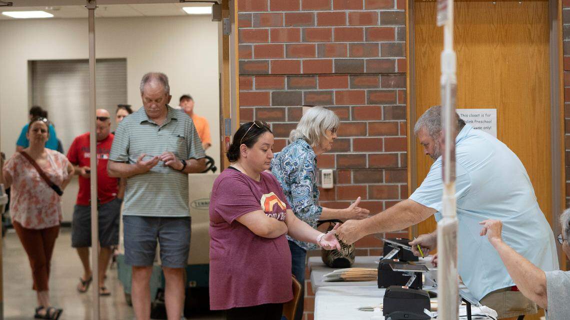 Voters check into Pathway Church at 2001 N Maize Rd