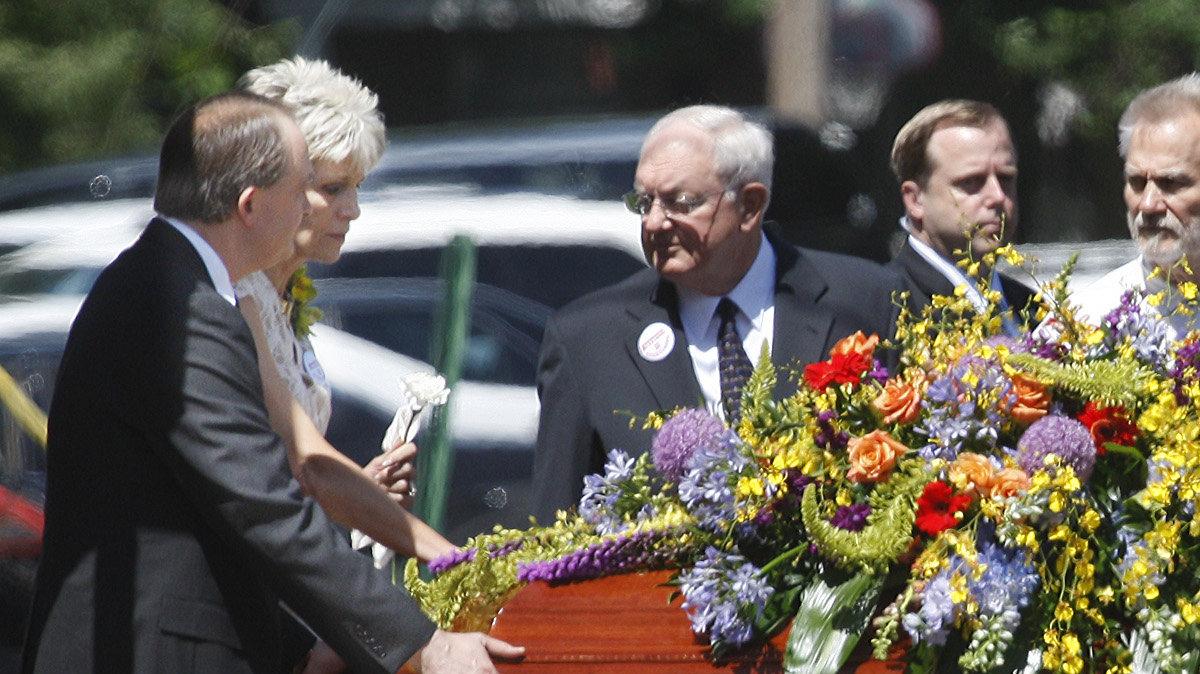 Jeanne Tiller, far left, escorts her late husband's casket from College Hill United Methodist Church after the service for Dr. George Tiller, who was shot last Sunday.