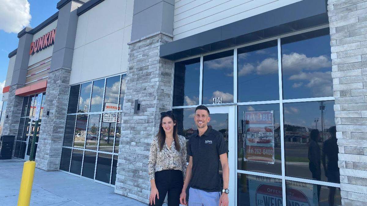 Patterson Legal Group has signed a lease for a new south-side office at 47th South and Broadway in the same center as Dunkin’. It continues to renovate a new west-side headquarters as well. Pictured is broker Krista Racine, who handles the firm’s real estate deals, and lawyer Tyler Patterson.