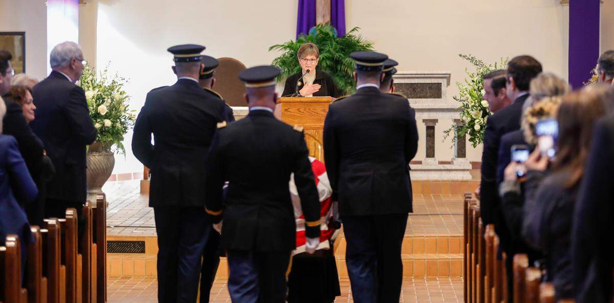Kansas Gov. Laura Kelly places her hand over her heart as the body of former Kansas senator Bob Dole is brought to the front of St. Mary Queen of Angels Catholic Church in Russell, Kansas, during Dole’s memorial service on Saturday.