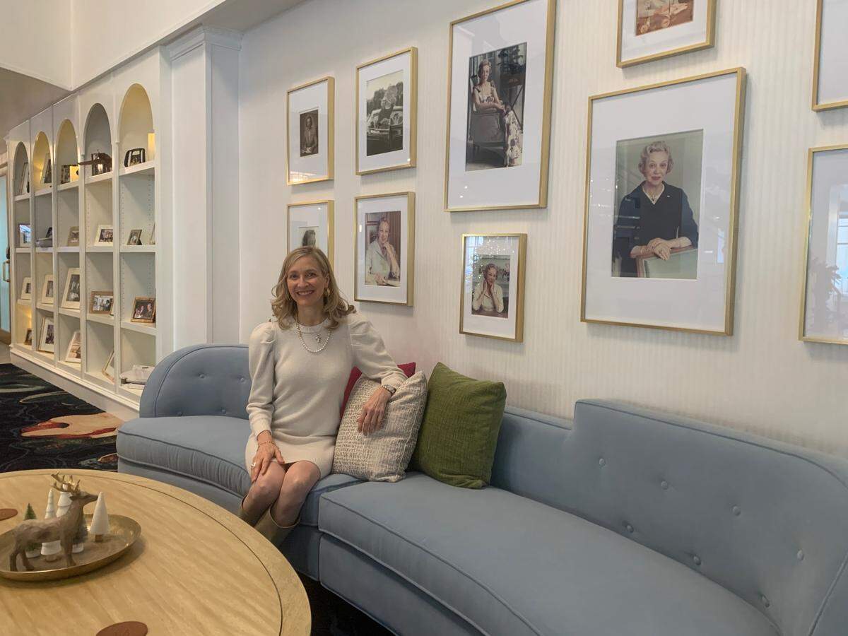 Jennifer Pitt pictured with some of her grandmother Olive Ann Beech’s photos at the new Olive Ann Hotel in Grand Forks, N.D. Pitt supplied some of the photos the hotel features.