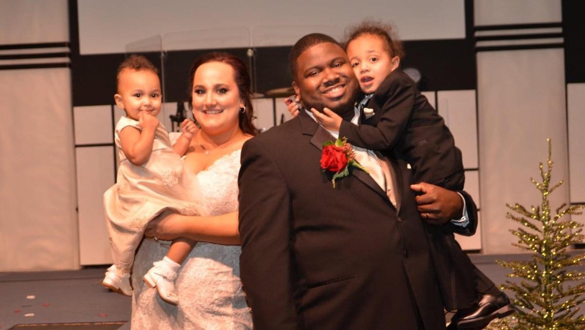 Preston Spencer, second from right, is pictured with his wife, Kendra, and their two children.