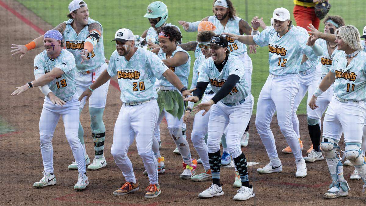 The Loco Beach Coconuts perform a group dance after scoring a run against the Firefighters at Equity Bank Park on Thursday night.
