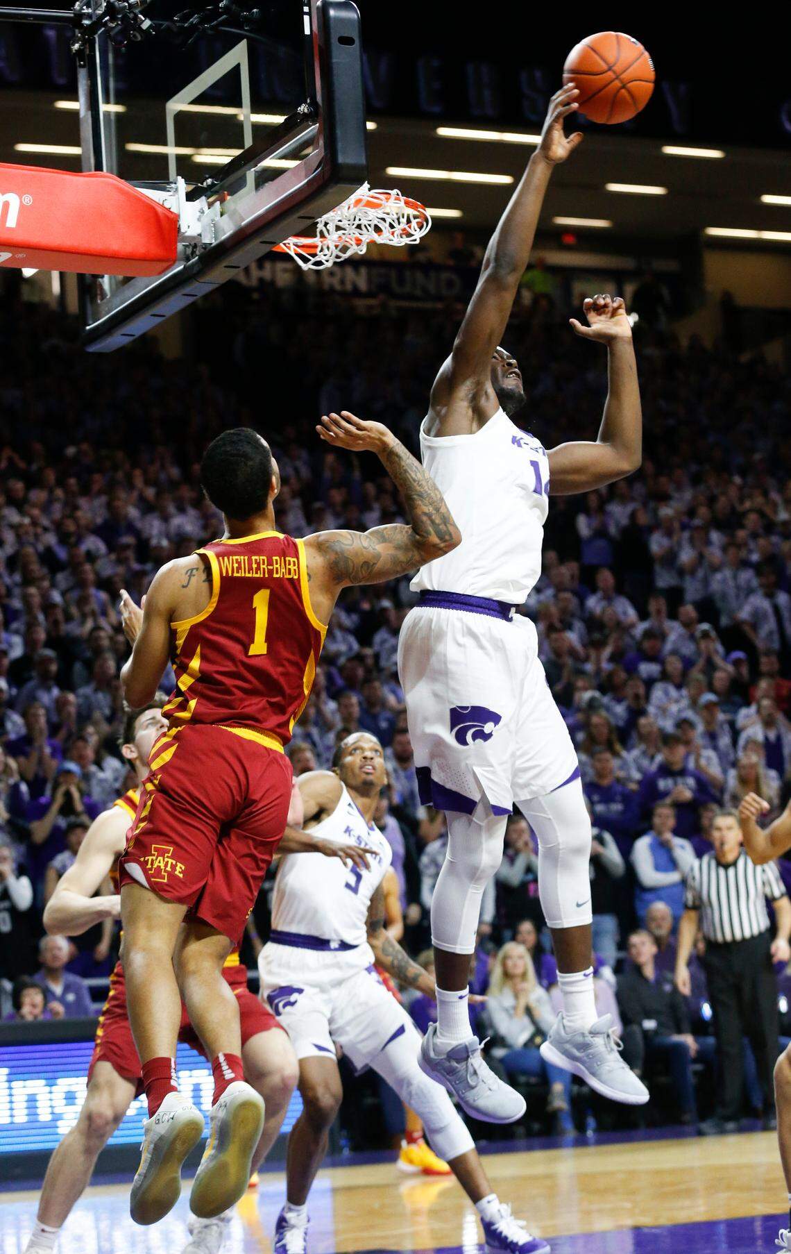 K-State forward Makol Mawien (14) swats away a shot by Iowa State guard Nick Weiler-Babb (1) in the first half Saturday in Bramlage Coliseum as Iowa State took on K-State.(February 16, 2019)