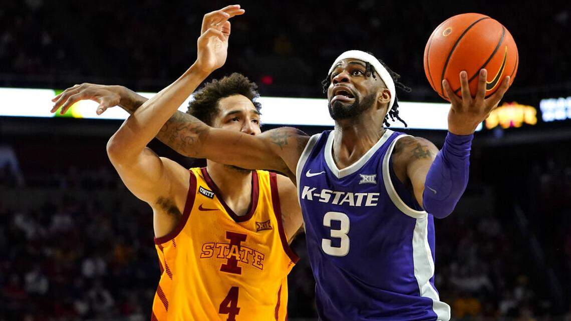 Kansas State guard Selton Miguel (3) is fouled by Iowa State forward George Conditt IV (4) while driving to the basket during the second half of an NCAA college basketball game, Saturday, Feb. 12, 2022, in Ames, Iowa. (AP Photo/Charlie Neibergall)