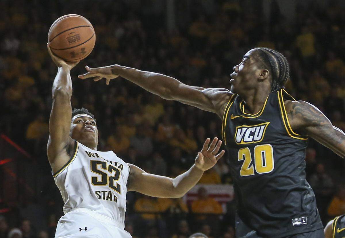 Wichita State’s Grant Sherfield shoots over VCU forward Hason Ward during the first half of their game at Koch Arena on Saturday.