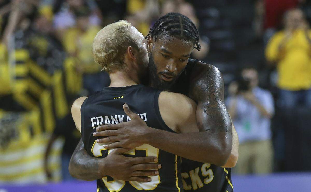 The Aftershocks’ Conner Frankamp, left, and Rashard Kelly embrace after defeating the Air Raiders, a team of Texas Tech Alum, during the second round of The Basketball Tournament on Saturday night.