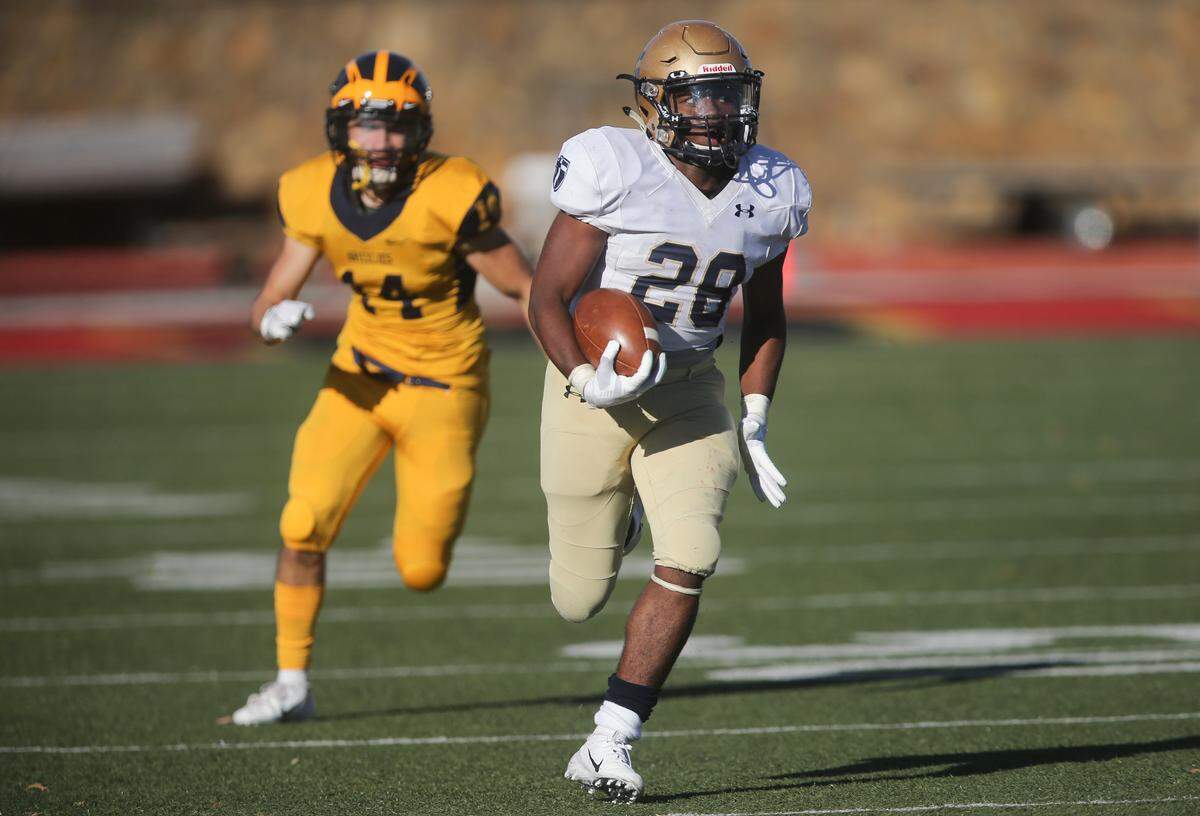 St. Thomas Aquinas’ Tyron Young scores a touchdown in the 3rd quarter of the 5A state title game against Wichita Northwest on Saturday in Pittsburg. 