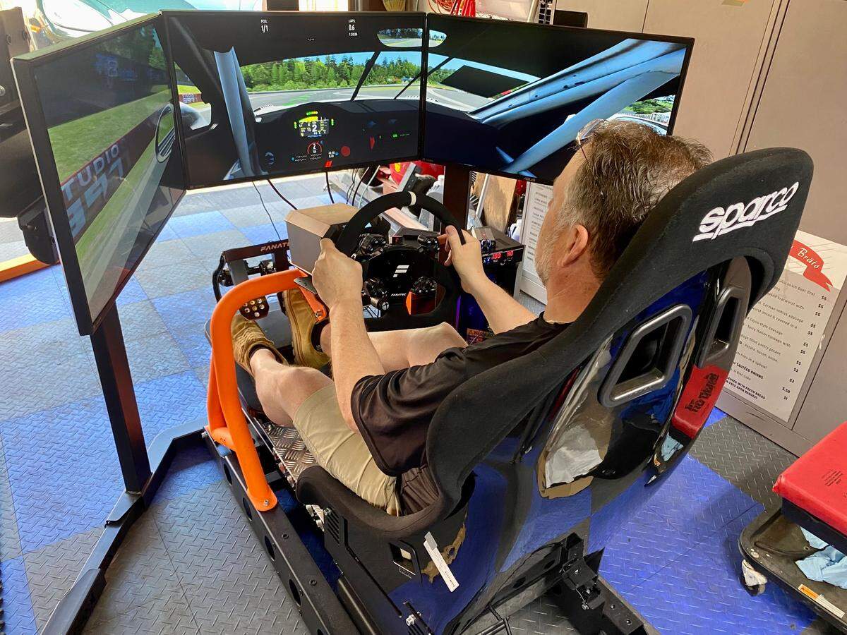 Glas Haus Racing owner Austin English demonstrates one of the rigs that will be set up in his new sim racing business, Glas Haus Racing.
