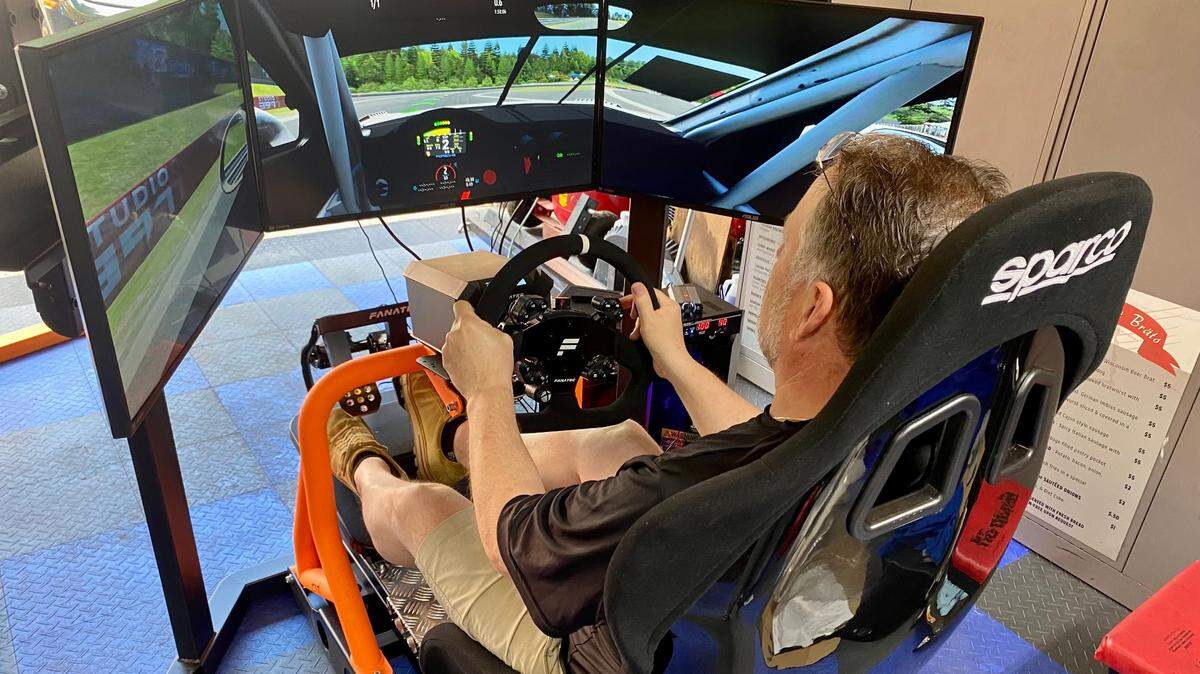 Glas Haus Racing owner Austin English demonstrates one of the rigs that will be set up in his new sim racing business.