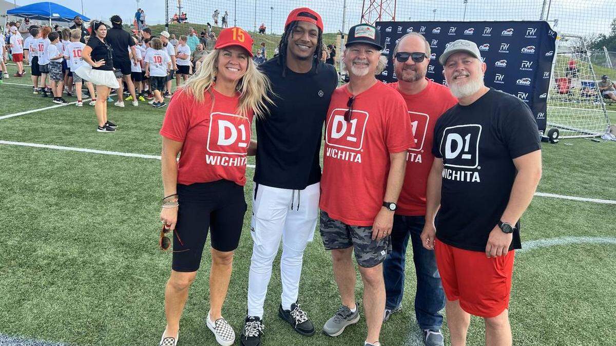 The Suellentrop siblings, including David Suellentrop, right, Brian Suellentrop, second from right, Paul Suellentrop, center, and Jennifer Lines, left, have opened two D1 Training franchises in Wichita. They’ve already been promoting youth athletics, including at the FLEXWORK football camp with Chiefs running back Isiah Pacheco, pictured second from left. The family continues to support the camp.