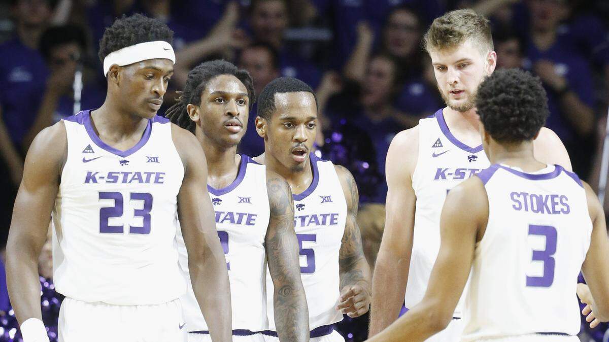 K-State basketball players meet during a break in action.