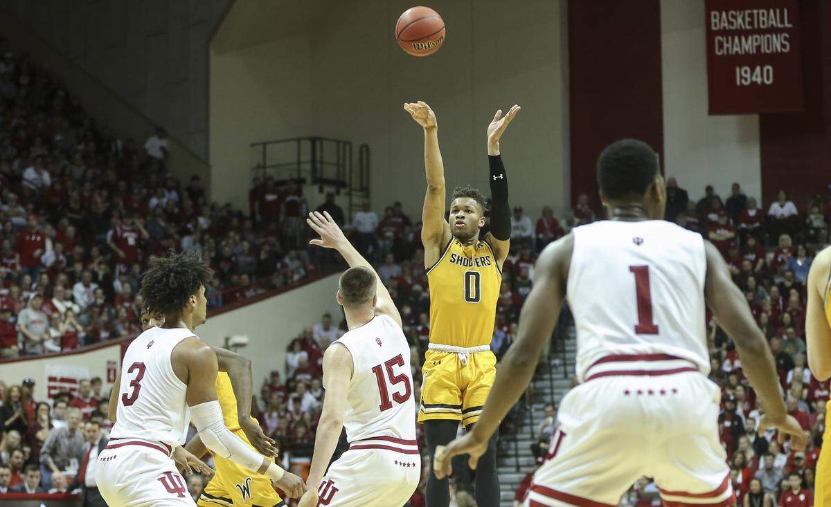 Dexter Dennis shoots a three over Indiana’s Zach McRoberts during the second half of their NIT quarterfinal game at Assembly Hall in Bloomington, Indiana on Tuesday.