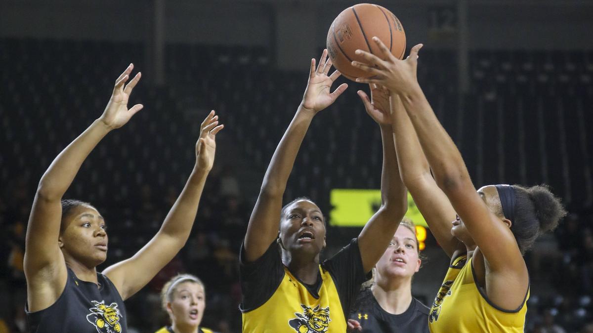 Wichita State forward Raven Prince, forward Sabrina Lozada-Cabbage and center Asia Henderson fight for a rebound during the Black and Yellow Scrimmage in Koch Arena. (Oct. 6, 2018)

