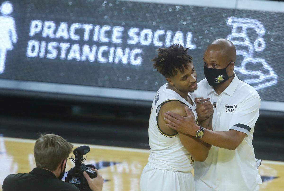 Interim Wichita State head coach Isaac Brown congratulates Tyson Etienne after Etienne poured in 26 point against Oral Roberts University in a 85-80 victory.