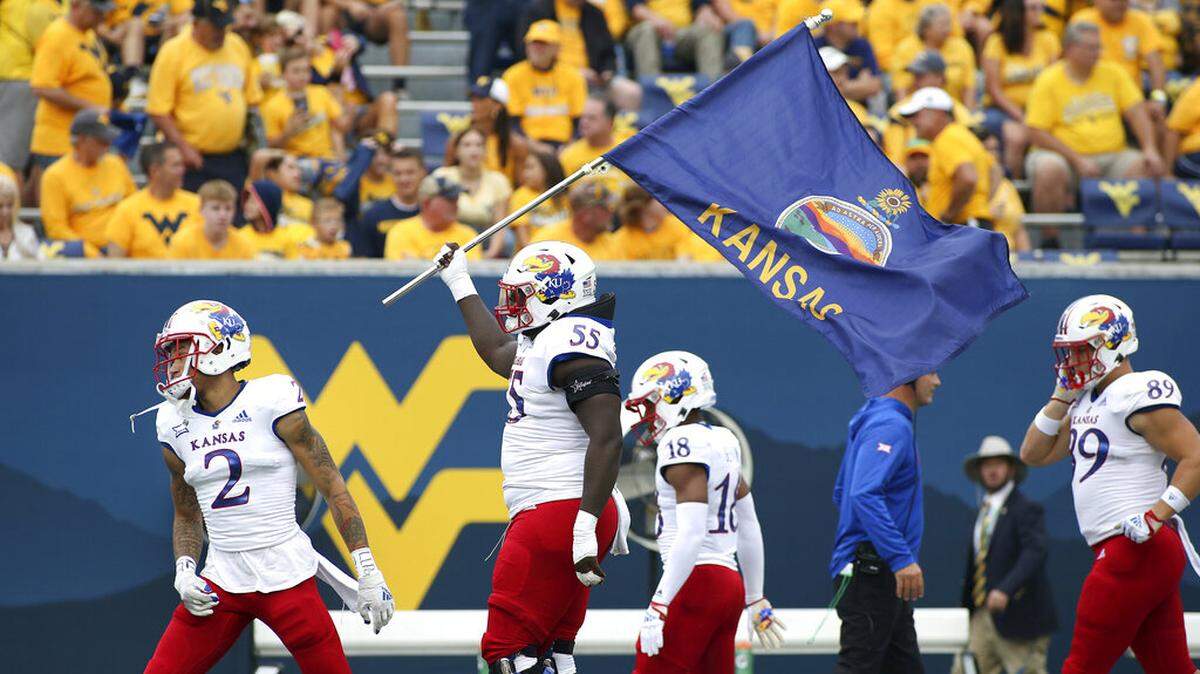 Kansas players take the field during the first half of an NCAA college football game against West Virginia in Morgantown, W.Va., Saturday, Sept. 10, 2022. (AP Photo/Kathleen Batten)