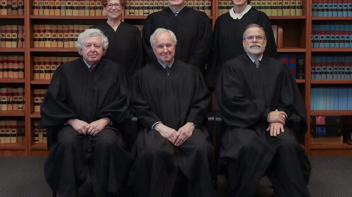 Kansas Supreme Court Justice K.J. Wall, standing at center, writes in an opinion issued Friday that the Supreme Court must follow the letter of state law on sentencing set forth by the Kansas Legislature despite claims by prosecutors the results are “absurd.”