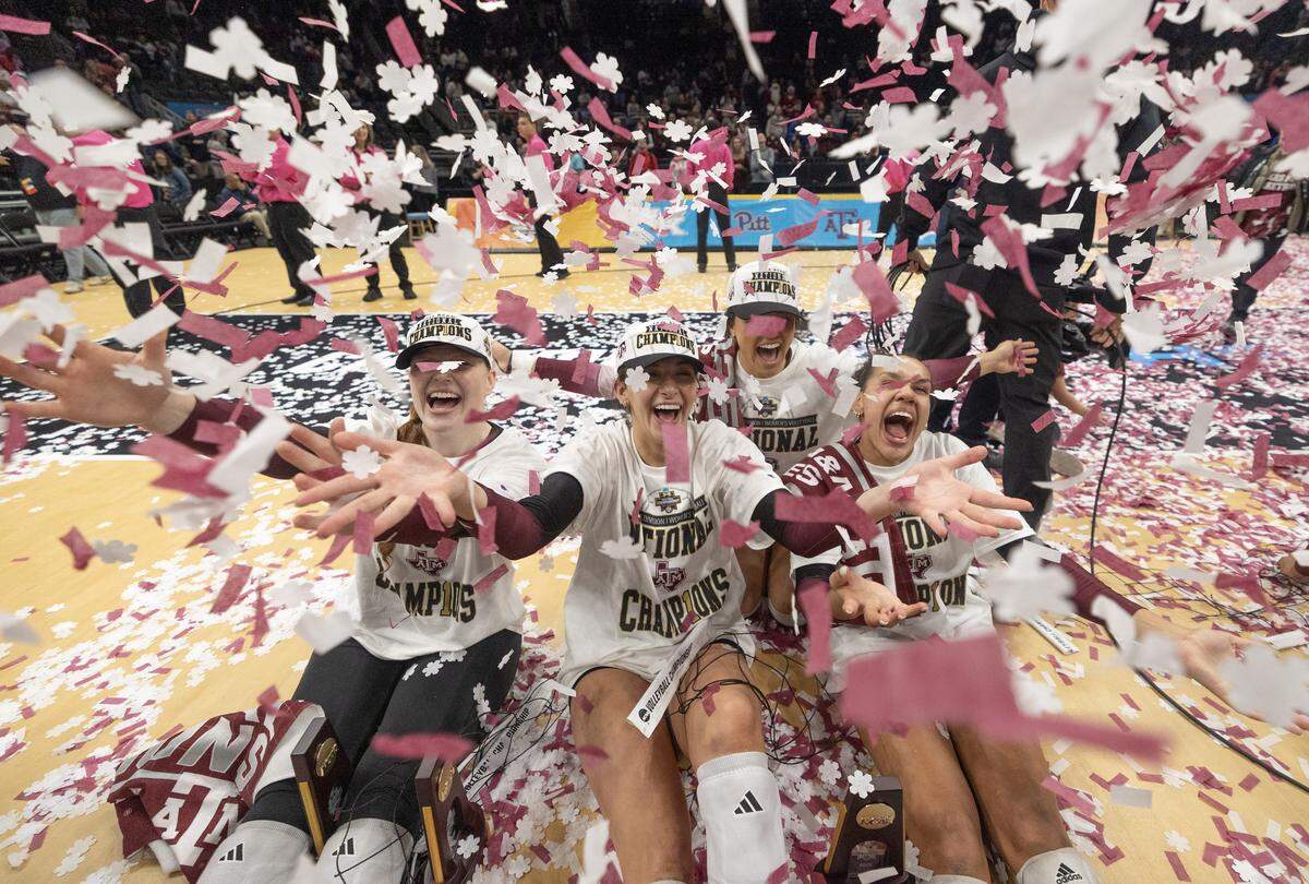 Texas A&M players toss confetti after defeating Kentucky in the championship match of the NCAA Women’s Volleyball Championship on Sunday afternoon at the T-Mobile Center.