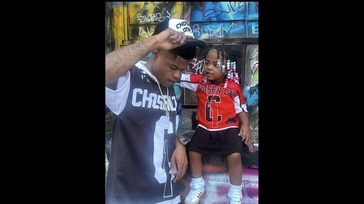 Knowledge McPherson and his daughter, Kelaia McPherson, modeling his clothing brand, Chosen One.