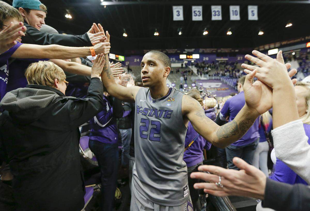 Kansas State senior Rodney McGruder is congratulated by fans after the Wildcats beat Texas Christian University in their home finale at Bramlage Coliseum in Manhattan on Tuesday night. Kansas State won 79-68. (March 5, 2013)