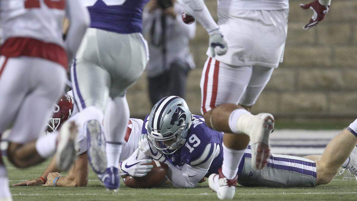 Kansas State defensive back Colby Moore recovers a fumble on a bad snap during a punt against OU during the second half on Saturday in Manhattan. 