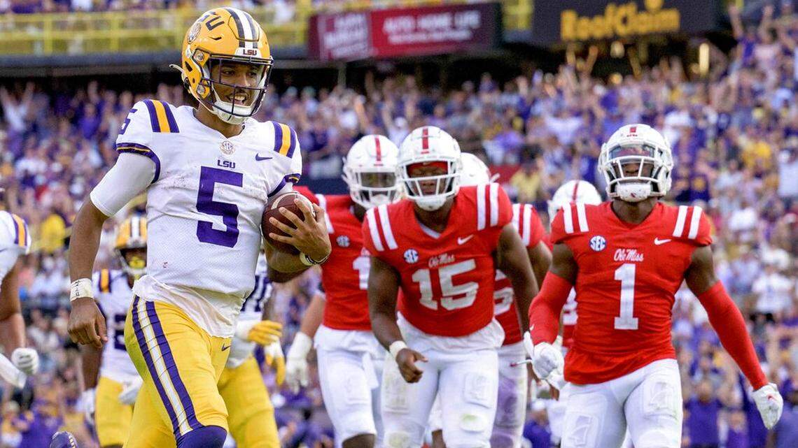 LSU quarterback Jayden Daniels (5) smiles as he scores a touchdown against Mississippi during the second half an NCAA college football game in Baton Rouge, La., Saturday, Oct. 22, 2022. (AP Photo/Matthew Hinton)