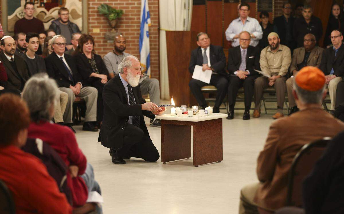 Rabbi Michael Davis led a community-wide prayer service at Congregation Emanu-El to honor the 11 Jewish people who were killed at the Tree of Life synagogue in Pittsburgh.