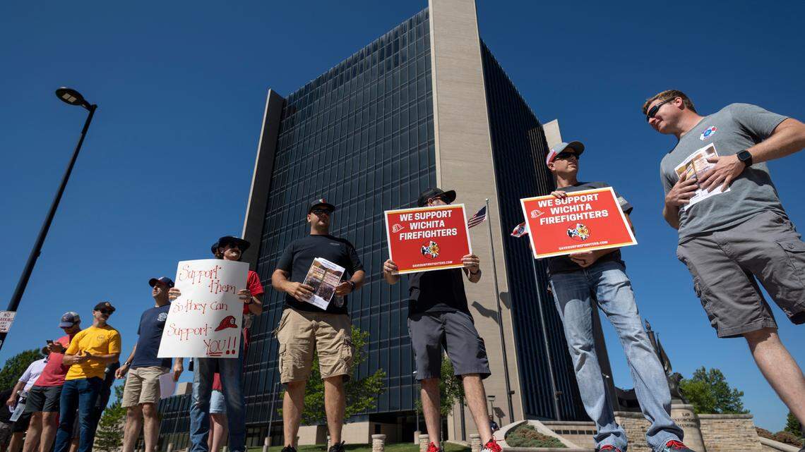 Wichita firefighters and their supporters staged a protest outside of Wichita City Hall on Tuesday morning.