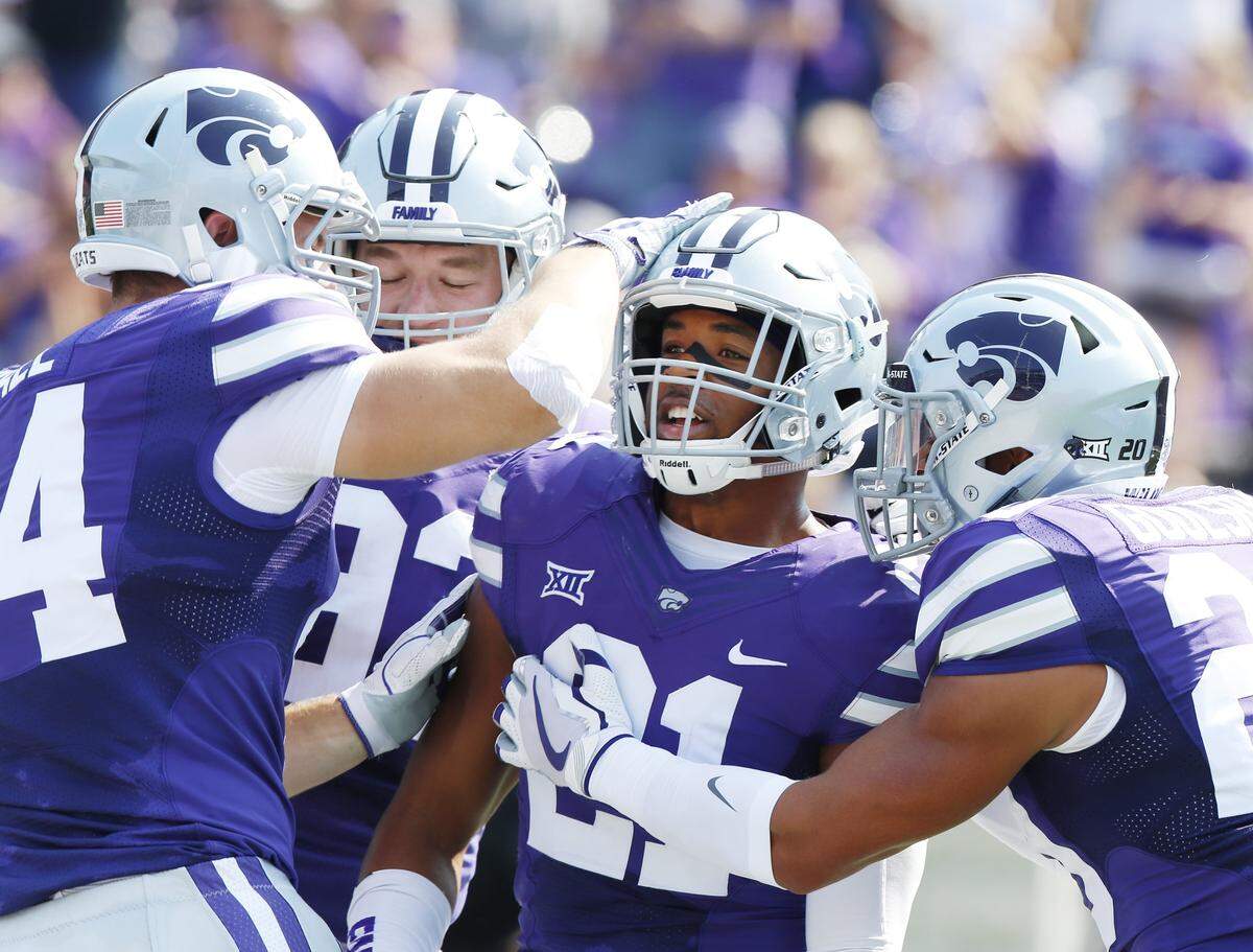 K-State defensive back Kendall Adams (21) celebrates after an interception touchdown against Charlotte. (September 9, 2017)